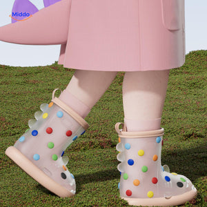 Shark rain boots paired with pink rain jacket, colorful and fun kids' outdoor gear.