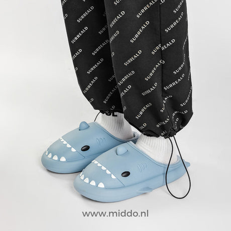Blue shark slippers in soft, cozy plush material.