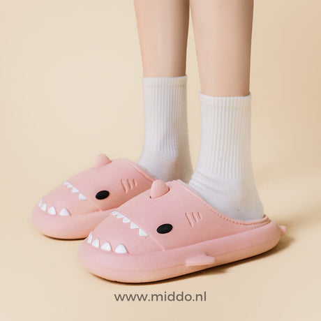 Pink shark slippers offering cozy, cute home comfort.