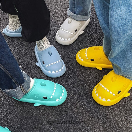 Cozy shark slippers keeping feet warm and dry for families.