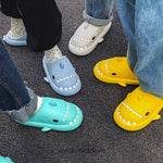 Cozy shark slippers keeping feet warm and dry for families.