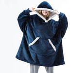Oversized sherpa fleece hoodie in blue with white trim detail and soft fleece interior.
