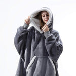 Oversized sherpa fleece hoodie in grey with white accent trim and plush lining.