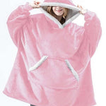 Oversized sherpa fleece hoodie in light pink with white trim and warmth-enhancing fabric.