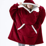 Oversized sherpa fleece hoodie in red with white trim and cozy fleece construction.