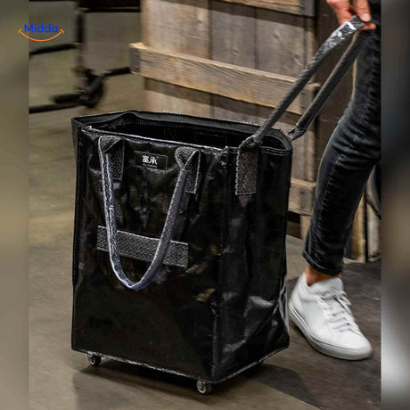 Black folding shopping trolley with long adjustable strap for groceries and laundry