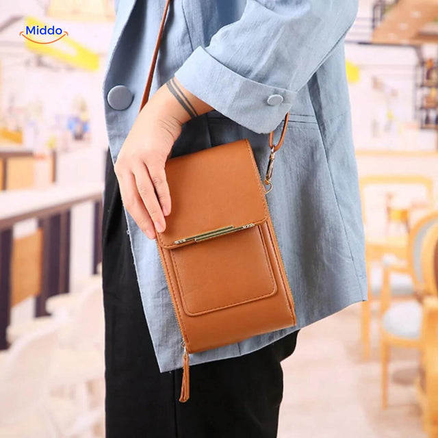 Woman wearing yellow TouchScreenGo shoulder bag with touchscreen back panel.