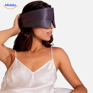 Model displaying pink silk sleep mask showing elegant design and secure comfortable positioning.