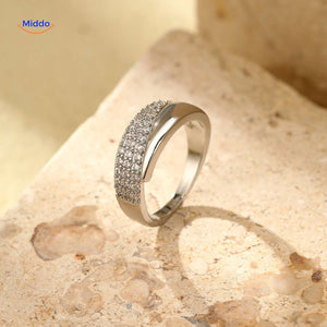 Silver-toned adjustable ring with sparkling zirconia on marble.