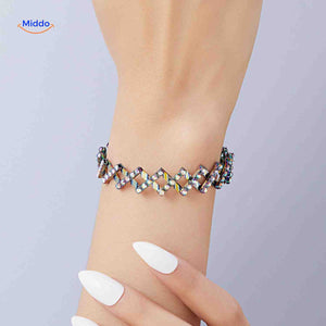 Silver adjustable bracelet with crystal rhinestone details, expandable design.