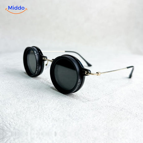 Round sunglasses with silver metal frame and UV light reduction lens.