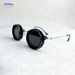 Round sunglasses with silver metal frame and UV light reduction lens.
