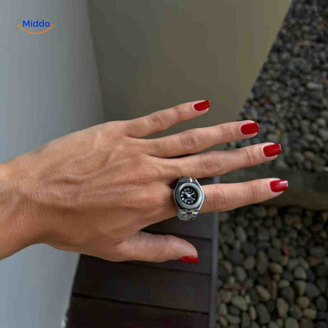 Silver womens ring watch with stylish aesthetic shown on hand.