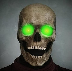 Skull mask with glowing green eyes for eerie Halloween decoration or costume.