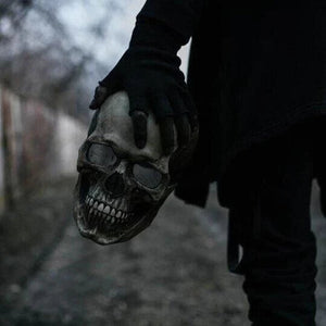 Hand holding the realistic skull mask to show size and lightweight design.