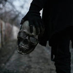 Hand holding the realistic skull mask to show size and lightweight design.