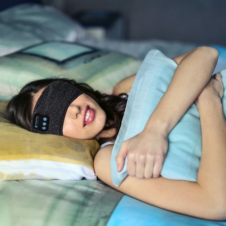Black sleep and sports headband combining comfort with versatile wireless use.