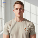 Close-up of smiley logo on beige cotton t-shirt showing print quality.