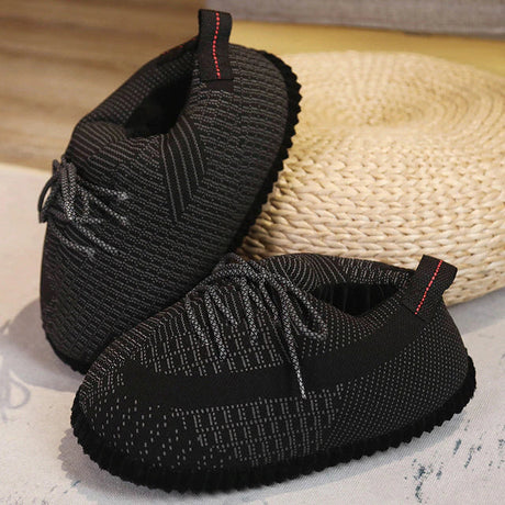 Black cozy sneaker slippers featuring anti-slip sole for everyday wear.