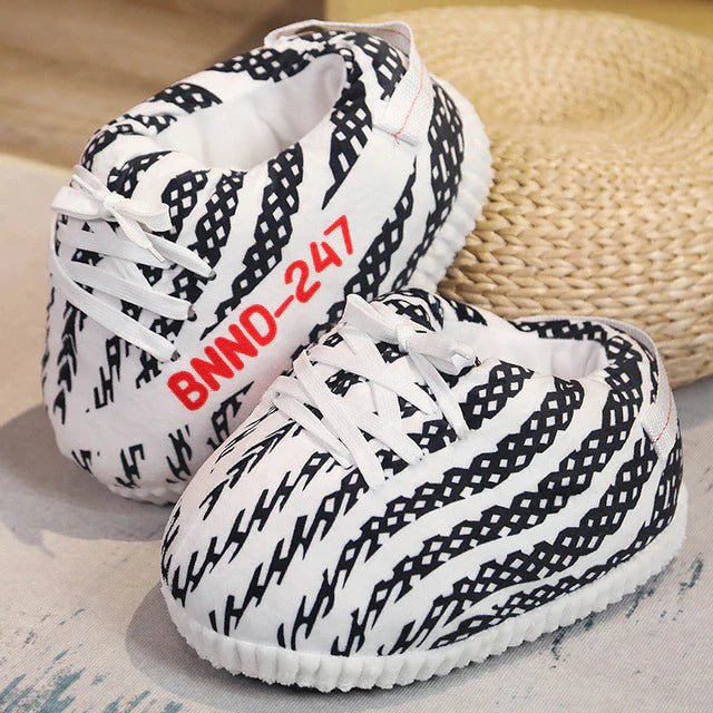 Striped black and white sneaker slippers combining style with comfort and grip.