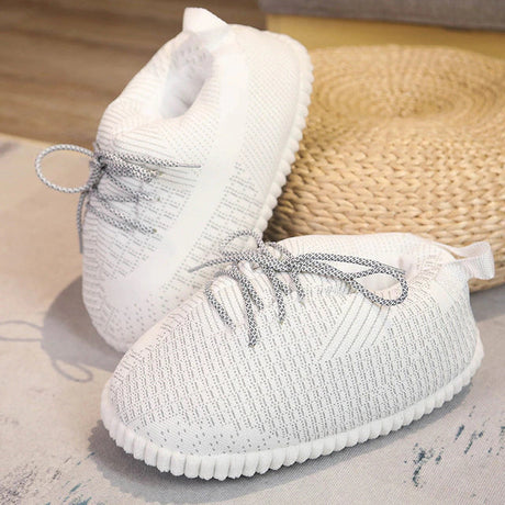 White warm sneaker slippers designed for comfort with secure traction.