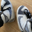 White and gray warm sneaker slippers providing cozy comfort with secure traction.