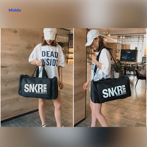 Person in gloves carrying SNKRPro sports travel bag in different angle.