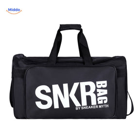 SNKRPro black sports travel bag held in hand with white text branding.