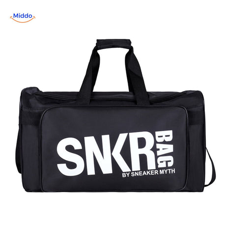 SNKRPro black sports travel bag held in hand with white text branding.