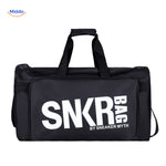 SNKRPro black sports travel bag held in hand with white text branding.