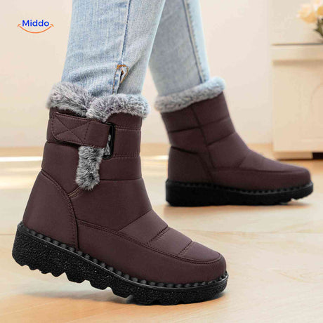 Brown SnowLuxe snow boots with water-repellent surface to keep feet dry.