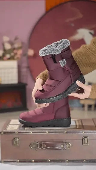 Red SnowLuxe waterproof snow boots with fur lining for reliable winter protection.