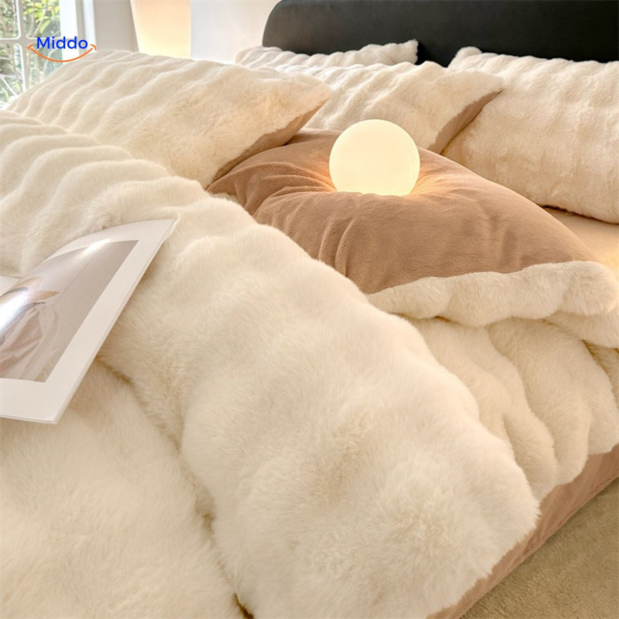 White plush bedding set with soft fabric and bedroom lighting.
