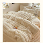 Complete white plush duvet cover set on comfortable bed.