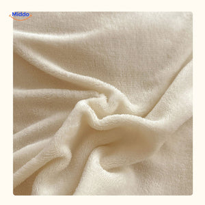 Soft white faux rabbit fur fabric detail of duvet cover.