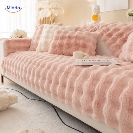 Pink and white plush furniture cover with cushions creates cheerful, cozy living space.