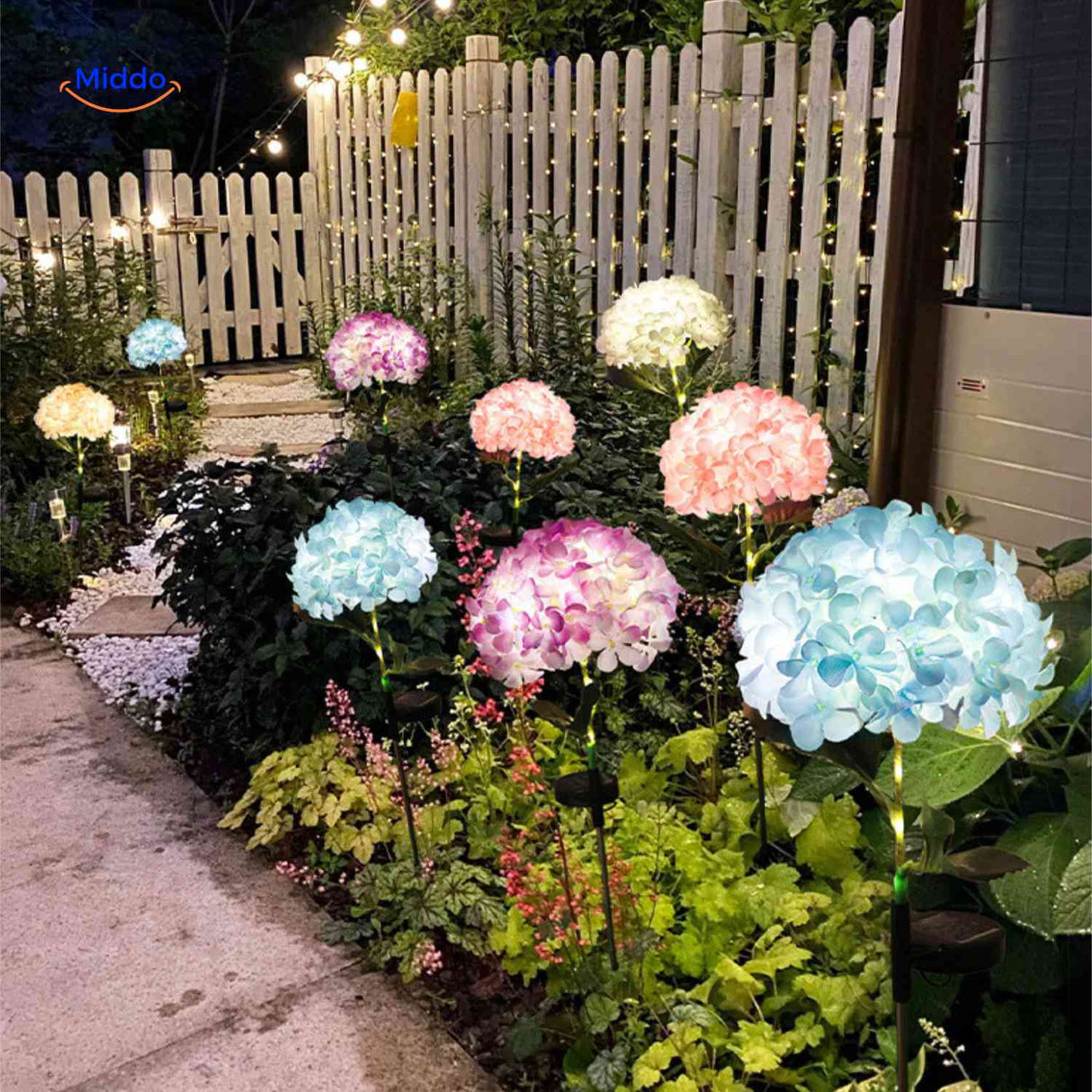 Solar flower lantern illuminating garden pathway with soft hydrangea blooms.