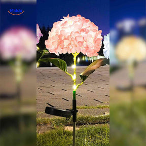 Solar-powered Florora flower lantern with peach hydrangea blooms and warm LED lighting.