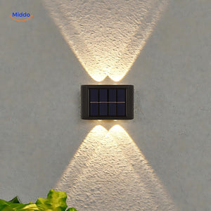 Solar wall light with warm white glow for garden, path, and patio illumination.