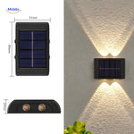 Dual-head solar wall light with warm white LED for ambient outdoor lighting.