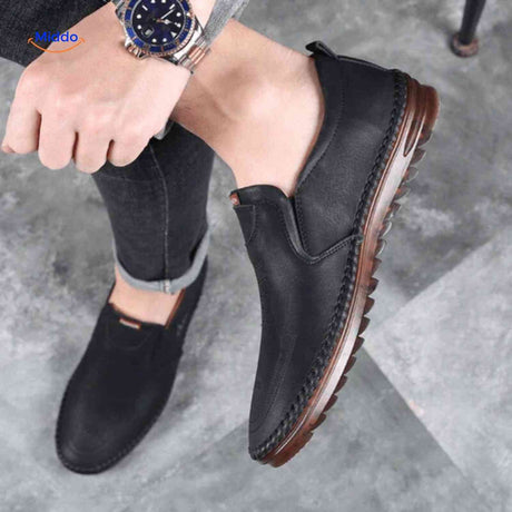 Black leather Solura loafers delivering slip-on comfort for men's casual wear.
