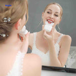 U-shaped sonic toothbrush shown reflecting in mirror during hands-free use.
