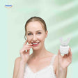 Woman smiling while using U-shaped sonic electric toothbrush with whitening effects.