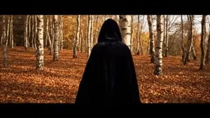 Black velvet Spookora cape in wooded forest setting creating spooky Halloween mood.