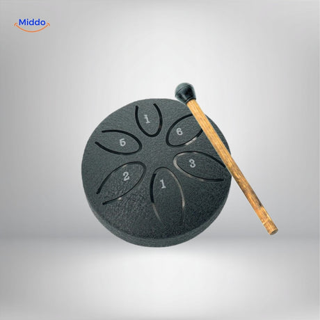 Steel tongue drum back view in bright yellow with drainage holes.