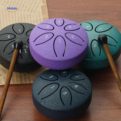 Purple steel tongue drum instrument with included beater mallet.