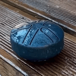 Steel tongue drum tested in rain demonstrating weather-resistant design.