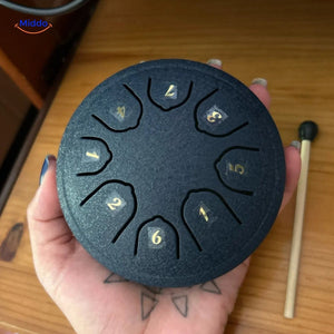 Compact handheld steel tongue drum in black mini size for portability.
