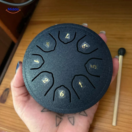 Compact handheld steel tongue drum in black mini size for portability.