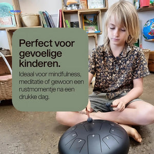 Child enjoying calming steel tongue drum for emotional regulation.